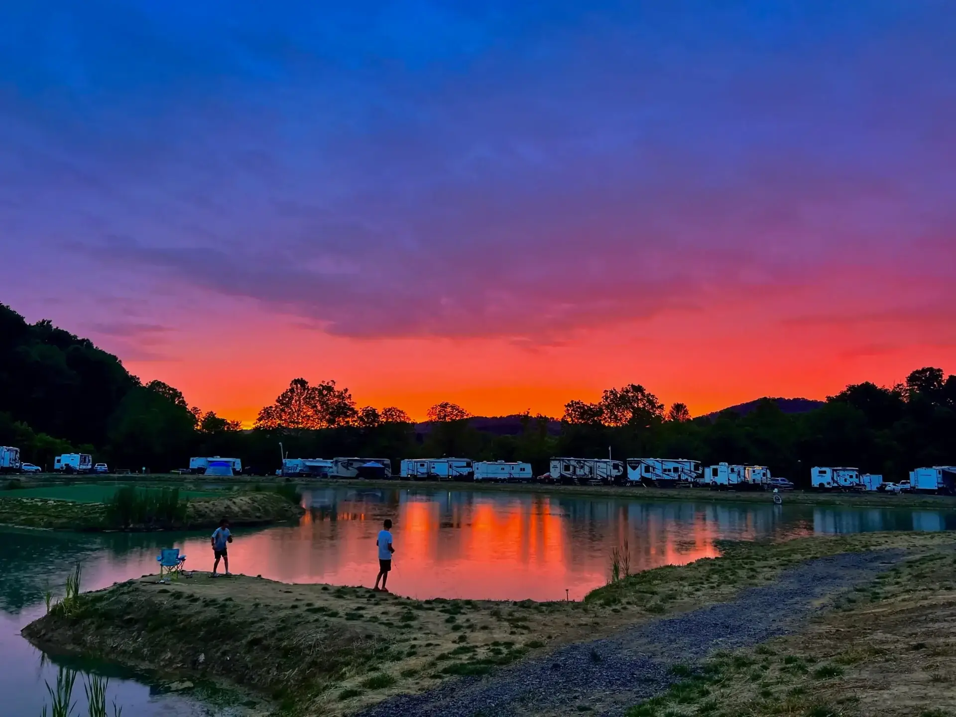 Aerial view of lakefront RV sites at sunset