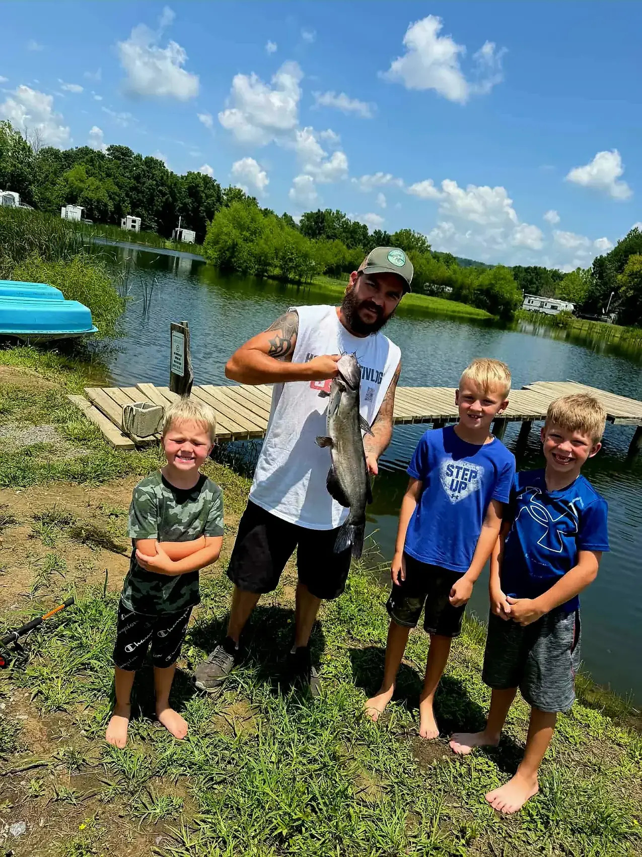 Family with a catfish catch by the lake