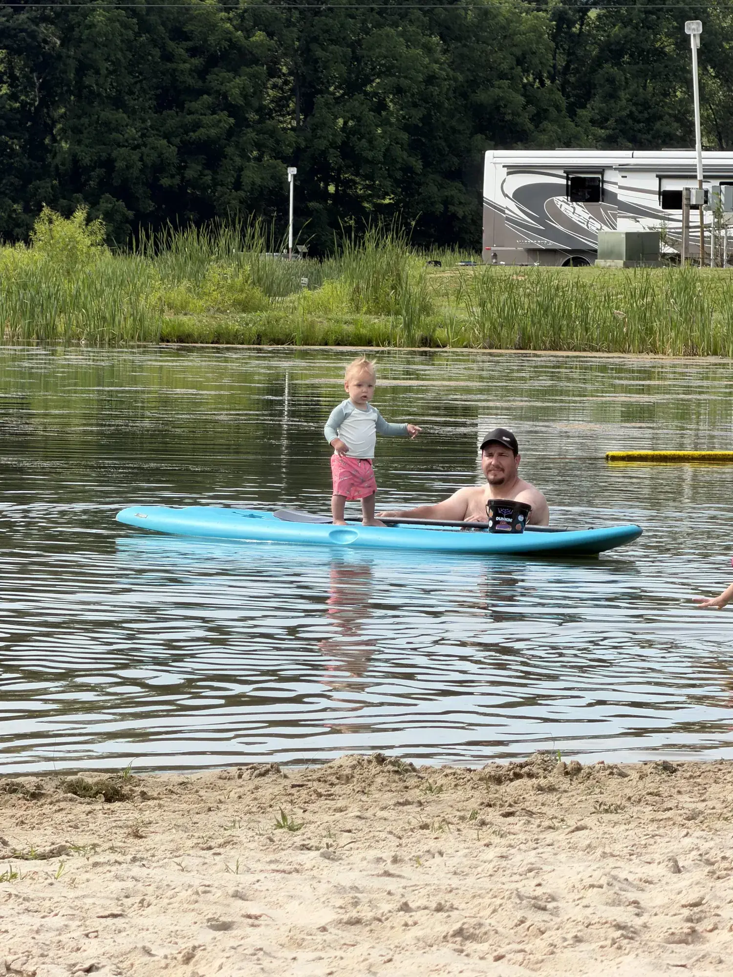 Family paddleboarding on the swimming lake